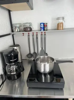 a kitchen counter with a pot on a stove at Nice and Cozy guest house 4 in Miami