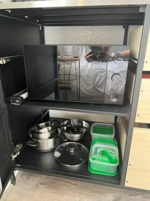 a small kitchen with a stove and some dishes at Nice and Cozy guest house 4 in Miami