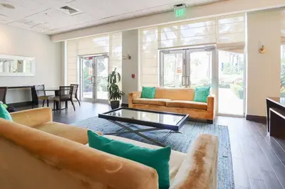 a living room with couches and a table at Apt w/2 Queen Beds & Canal View at Tides in Hollywood