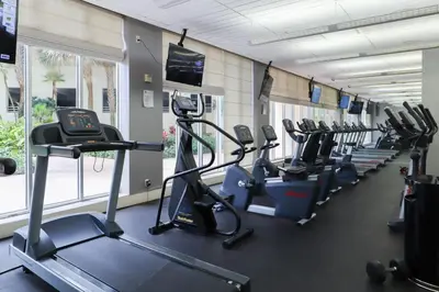 a gym with a row of treadms and cardio machines at 2Bed/2Bath, 4QueenBeds & OceanView at Tides in Hollywood