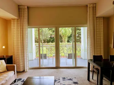 a living room with sliding glass doors leading to a patio at Doral Pool 1107 by Wave Properties in Miami