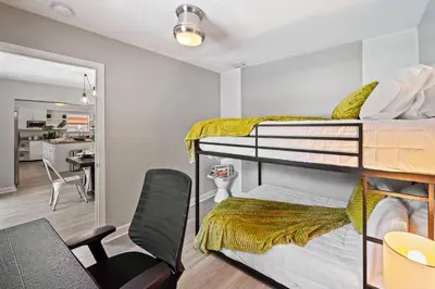 a bedroom with two bunk beds and a desk at Casa Mojito in Fort Lauderdale