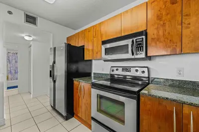 a kitchen with a stove and a microwave at Comfy 28th floor • Brickell • Ocean & City Views in Miami