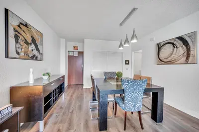 a kitchen and dining room with a table and chairs at Spacious 1 BDR 1.5 BTH • Hallandale Beach in Hollywood