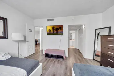 a room with two beds and a bench in it at Spacious 1 BDR 1.5 BTH • Hallandale Beach in Hollywood