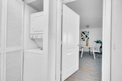 a white hallway with a door leading to a dining room at Stunning 1 BDR 1 BTH • Brickell • Bay & City Views in Miami