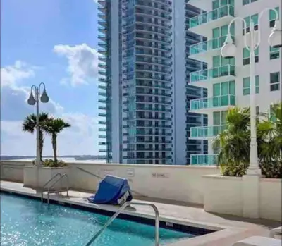 a swimming pool with a view of a tall building at Stunning 1 BDR 1 BTH • Brickell • Bay & City Views in Miami