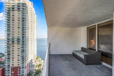 a balcony with a couch and a view of the ocean at Stunning 1 BDR 1 BTH • Brickell • Bay & City Views in Miami