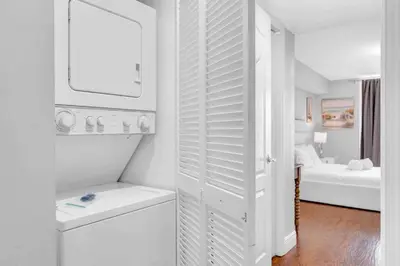 a white bathroom with a white closet with a bed at Beautiful 1 BED 1 BTH • Brickell in Miami