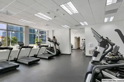 a gym with cardio equipment and a woman on a treadmill at Exquisite 1 Bed • 33 Floor •Brickell • Ocean Views in Miami
