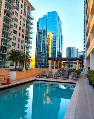 a swimming pool in a city with tall buildings at 35th floor 1 BED 1 BTH • Brickell • Ocean View in Miami