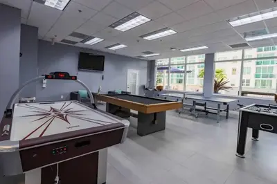 a large room with a pool table and ping pong tables at 35th floor 1 BED 1 BTH • Brickell • Ocean View in Miami