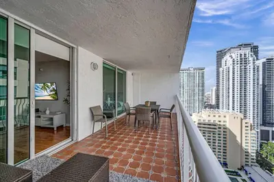a balcony of a building with a table and chairs at 35th floor 1 BED 1 BTH • Brickell • Ocean View in Miami