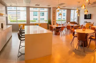 a dining room with tables and chairs and windows at 35th floor 1 BED 1 BTH • Brickell • Ocean View in Miami