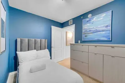 a blue bedroom with a bed and a dresser at PH 41st Floor 3 BED • Brickell • Ocean View in Miami
