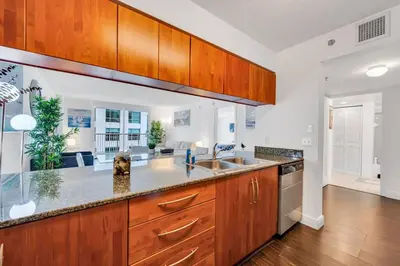 a kitchen with wooden cabinets and a sink at Dazzling 1 BED 1 BTH • Brickell • Bay & City View in Miami