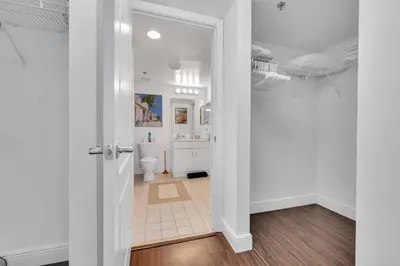 a white bathroom with a toilet and a sink at Dazzling 1 BED 1 BTH • Brickell • Bay & City View in Miami