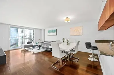 a kitchen and living room with a table and chairs at Splendid 1 Bed Apartment • Brickell • Water Views in Miami