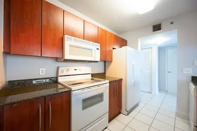 a kitchen with a white stove and a refrigerator at Splendid 1 Bed Apartment • Brickell • Water Views in Miami