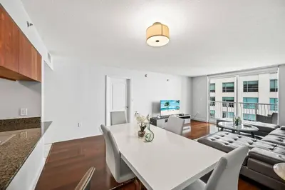 a living room with a white table and chairs at Splendid 1 Bed Apartment • Brickell • Water Views in Miami