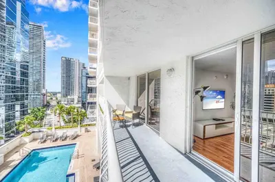 an apartment with a pool and a view of the city at LUX 1 BDR 1 BTH • Brickell • Pool & Ocean Views in Miami