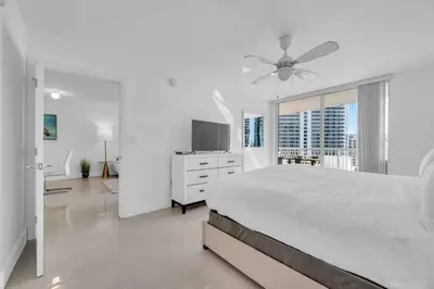 a white bedroom with a bed and a ceiling fan at Luxe 1 BDR •Brickell• Ocean View in Miami