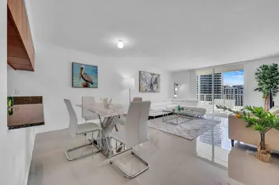 a dining room and living room with a table and chairs at Luxe 1 BDR •Brickell• Ocean View in Miami
