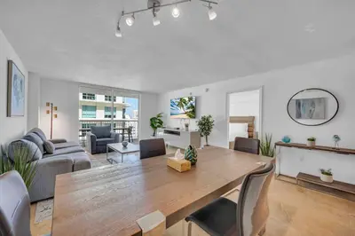 a living room with a wooden table and a couch at Spacious 36th FLR 1 BD 1 BT • Brickell • Bay View in Miami