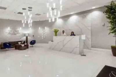 two people standing at a counter in a lobby at Spacious 36th FLR 1 BD 1 BT • Brickell • Bay View in Miami
