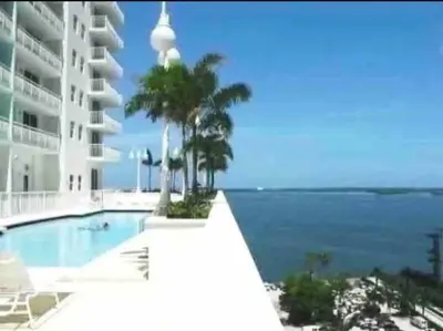 a swimming pool with a view of the ocean at Spacious 36th FLR 1 BD 1 BT • Brickell • Bay View in Miami