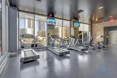 a gym with several cardio equipment in a building at Beachwalk Resort infinity Pool Balcony Views in Hallandale Beach