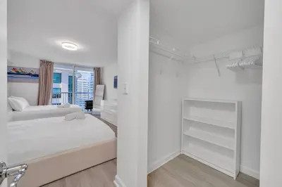 a white bedroom with a bed and a mirror at Beautiful 1 Bed 1 Bath • Brickell • Bay View in Miami