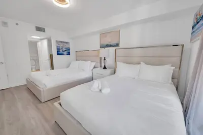 a bedroom with two beds with white sheets at Beautiful 1 Bed 1 Bath • Brickell • Bay View in Miami