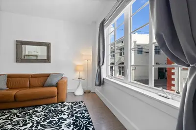 a living room with a couch and a large window at 1 Bedroom Jr Suite - Ocean Drive & 6th Str in Miami Beach