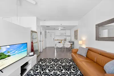 a living room with a couch and a flat screen tv at 1 Bedroom Jr Suite - Ocean Drive & 6th Str in Miami Beach