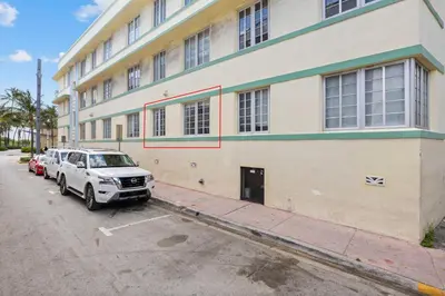 a white suv parked in front of a building at 1 Bedroom Jr Suite - Ocean Drive & 6th Str in Miami Beach