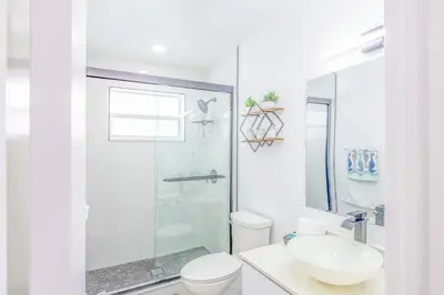 a white bathroom with a toilet and a sink at Havana Blue/Pool+Heater/Hard Rock/Gazebo/BBQ in Miami