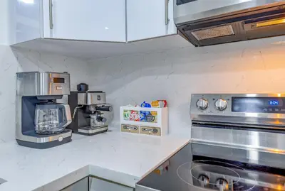a kitchen with a stove and a coffee maker at Havana Blue/Pool+Heater/Hard Rock/Gazebo/BBQ in Miami
