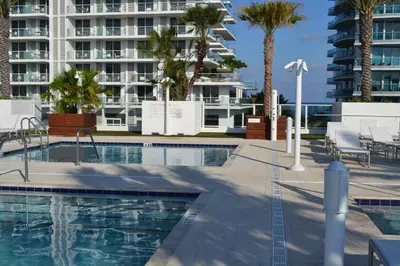 a swimming pool with a building in the background at Grand Beach Hotel Surfside West in Miami Beach