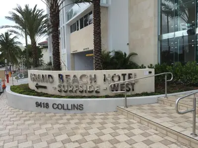 a sign for a hotel in front of a building at Grand Beach Hotel Surfside West in Miami Beach