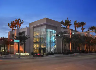 a large building with palm trees in front of it at Grand Beach Hotel Surfside West in Miami Beach