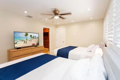 a bedroom with two beds and a flat screen tv at Amazing Villa WALK 5 minutes to Hollywood Beach in Hollywood