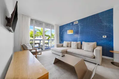 a living room with a couch and a table at Beachwalk -1 Bedroom With Kitchen Pool And Gym in Hallandale Beach