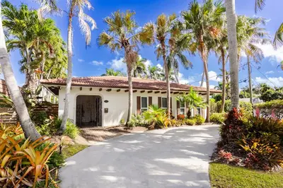 a house with palm trees and a driveway at Breathtaking 5BR & 3BA Villa near Hollywood Beach in Hollywood