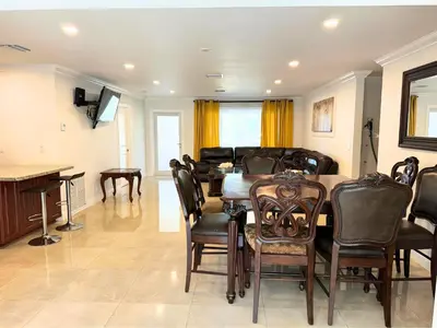 a dining room with a table and chairs at Spacious 4/4 Home Central To All Attractions in Hollywood