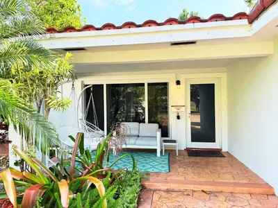 a white house with a white couch on a patio at Spacious 4/4 Home Central To All Attractions in Hollywood