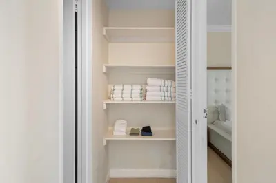 a walk in closet with white shelves and towels at PROMO Komffy Penthouse w King Bed and Ocean view at Tides 16th floor in Hollywood