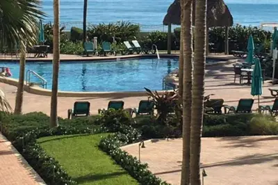 a swimming pool with chairs and the ocean in the background at PROMO Komffy Penthouse w King Bed and Ocean view at Tides 16th floor in Hollywood