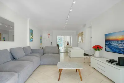 a living room with a couch and a tv at PROMO Komffy Home with King Bed & Ocean View at Tides 7th floor in Hollywood
