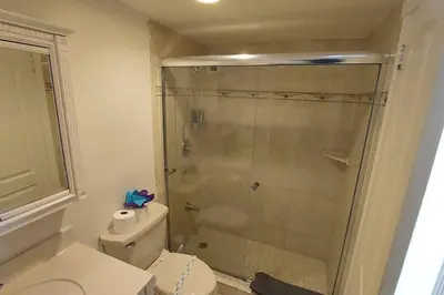 a bathroom with a toilet and a glass shower at PROMO Komffy Home with King Bed & Ocean View at Tides 7th floor in Hollywood